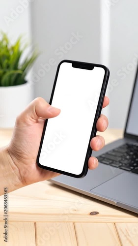 A hand holding a smartphone with a blank white screen