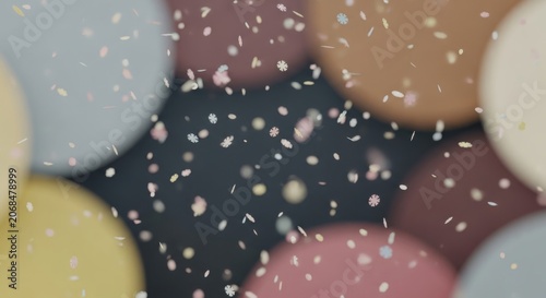 Colorful confetti falls on multicolored balls in a festive scene with confetti and spheres.