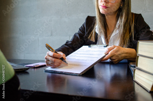 Attorney presenting accident release form and pen to client for signature