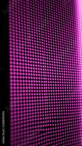 Abstract pink led screen with glowing digital dot pattern