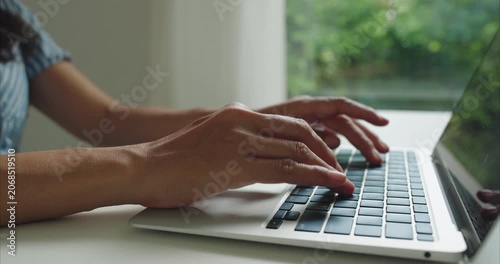 Close up. Hand of middle woman using laptop at home office natural light