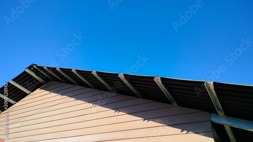 Onduline Roof on Residential House Against Blue Sky