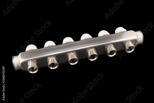 Hydronic control appliances for underfloor heating and cooling. Manifold assembly for floor heating. Collector group with 6 outputs. Isolated on a black background