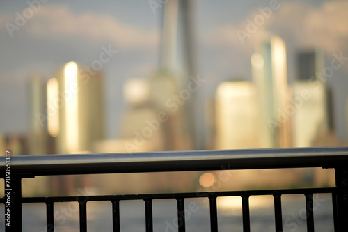 Blurred urban skyline viewed from a railing