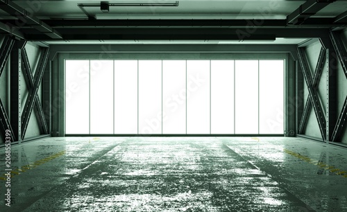 Dark, wet floor interior of a massive industrial hangar
