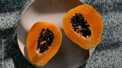 Fresh Papaya Halves on Plate in Natural Sunlight