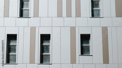 This structure features a modern building facade with a series of windows and geometric patterns.