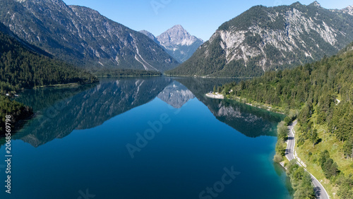 mountain lake reflection in the alps on a sunny day 