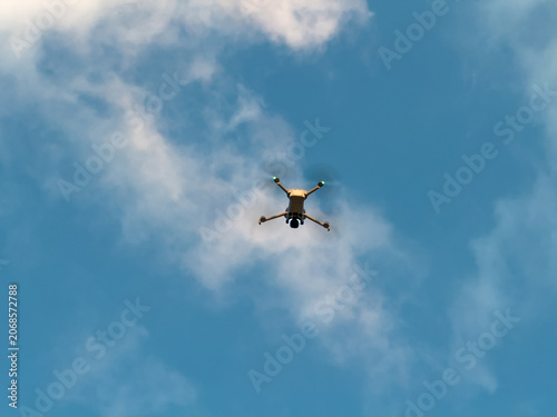 Tableau sur toile Drone flying in blue sky with clouds for technology concept
