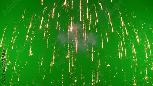 A vibrant explosion of red, white, and blue fireworks bursts against a bright green background, creating a dazzling display of light and color.