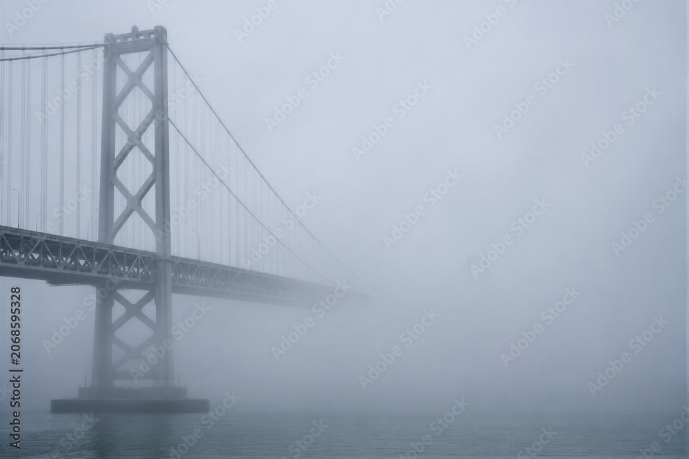 Fototapeta premium Foggy Bay Bridge Suspension Tower and Cables in San Francisco