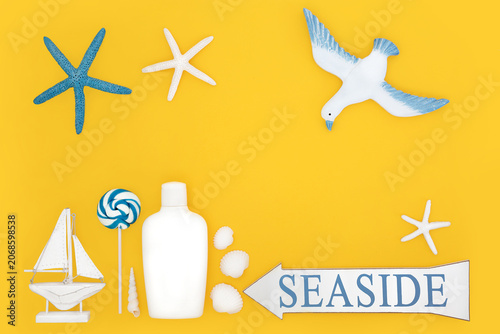 Foto Summer vacation fun at the seaside lifestyle  holiday symbols with sign, suntan lotion bottle, seagull, shells, sailboat, starfish, lollipop on yellow background