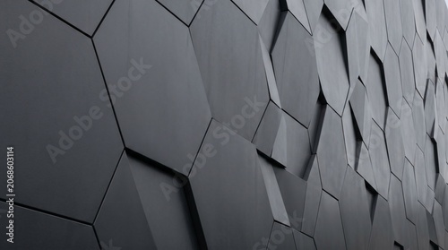 Abstract dark architectural wall featuring geometric patterns and sharp shapes with a modern industrial style