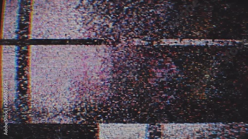 A close-up shot reveals a distressed and glitching brick wall, showcasing a chaotic blend of colors and textures.