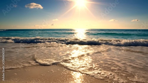 Golden sun shines over a tropical beach with crashing waves