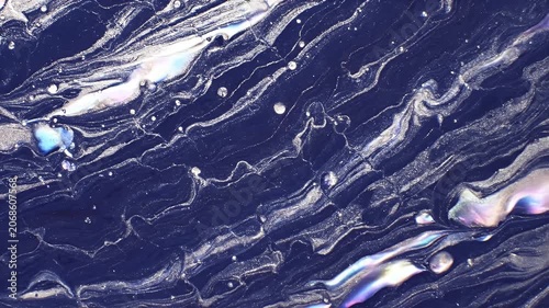 A mesmerizing abstract artwork showcases swirling patterns of deep blue and shimmering silver, creating a captivating visual experience.