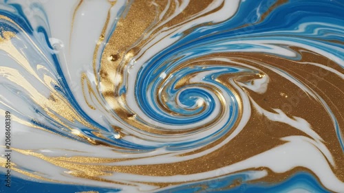 A close-up showcases a mesmerizing abstract painting featuring swirling patterns of gold and blue, resembling a dynamic ocean current or marbled stone.