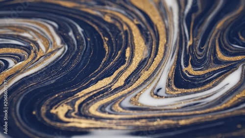 A mesmerizing abstract image showcases swirling patterns of deep blue, shimmering gold, and crisp white, resembling marbled stone or fluid art.