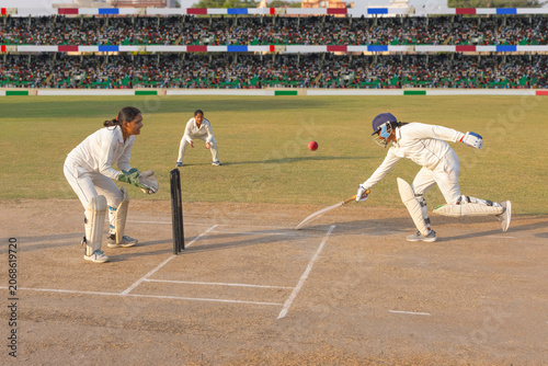 Batsman diving to make the crease in a cricket match