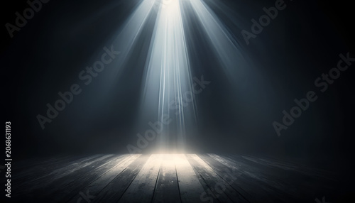 Spotlight shines downward onto a dark wooden surface creating a dramatic and moody illuminated area.