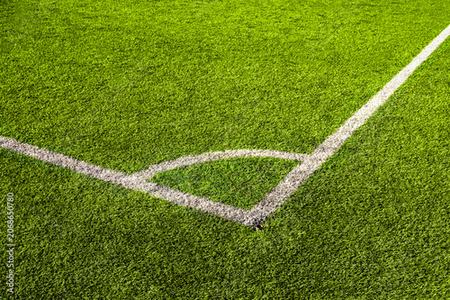 Obraz na plátně Top view of green artificial grass with white marking lines on soccer field