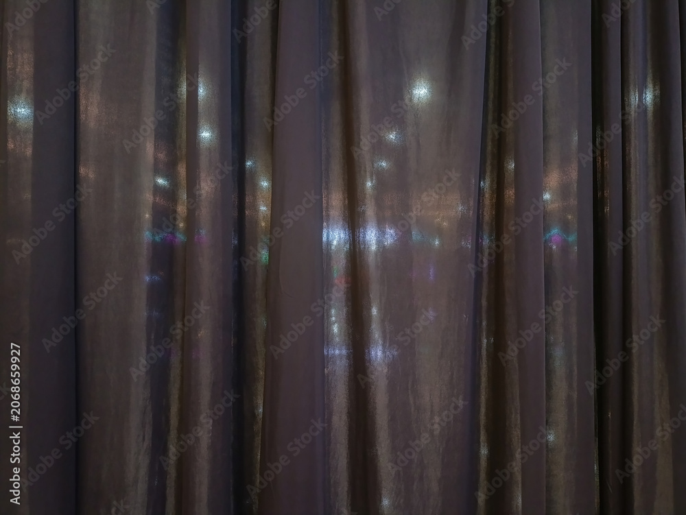 Obraz premium Black fabric curtain texture background with soft light shining through. Elegant folded dark drape panel abstract backdrop for interior design, theater, or stage concept.