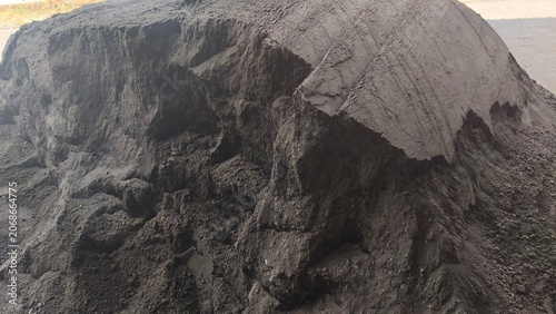 Bild auf Leinwand A large pile of volcanic black sand texture at a building construction site