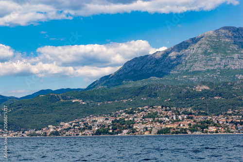 Breathable maritime view of the cascading stone town and coastal promenade of Herceg Novi from the open sea