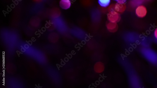 Abstract colorful bokeh lights with vibrant glowing spots and blurred dark background