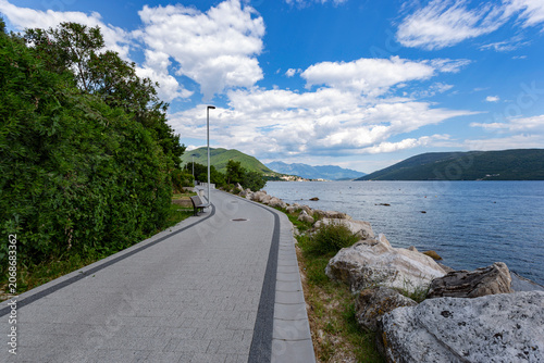Seaside promenade of Herceg Novi curving beautifully along the deep blue waters of the Bay of Kotor, Montenegro