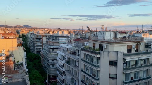Greece pan across Thessaloniki rooftop cityscape at sunset