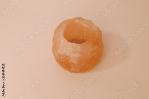 A crystal ring made from salt sits on a flat surface