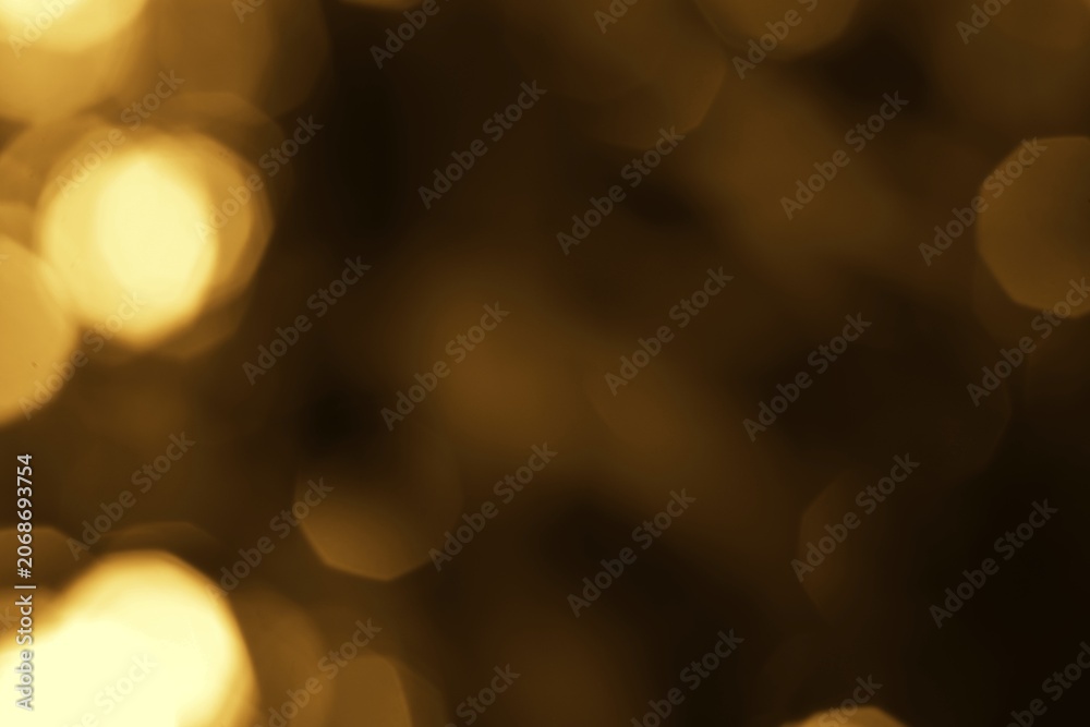 Fototapeta premium Abstract blurred glowing golden bokeh lights creating a warm ambient background</br>Golden Bokeh