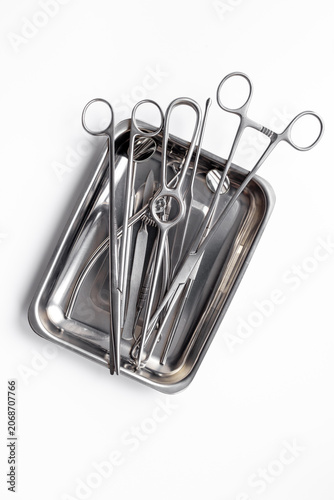 Sterile surgical instruments and tools - scalpels, scissors and others - in a stainless tray, top view