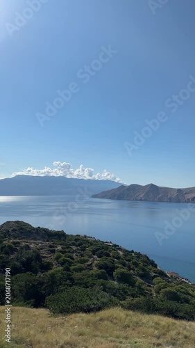 Calm sea and island view from grassy hillside