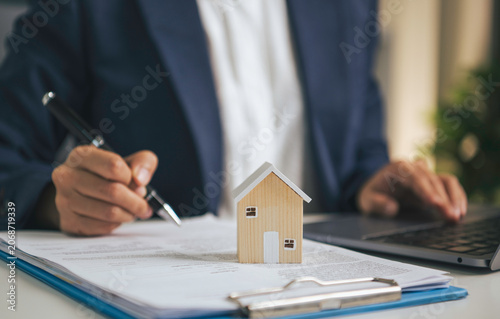Fotografie Home insurance and mortgage documentation concept with house model property prot
