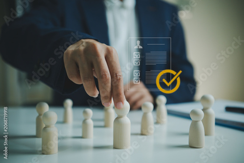 Bild auf Leinwand Employee selection approval with businessperson choosing candidate figurine for