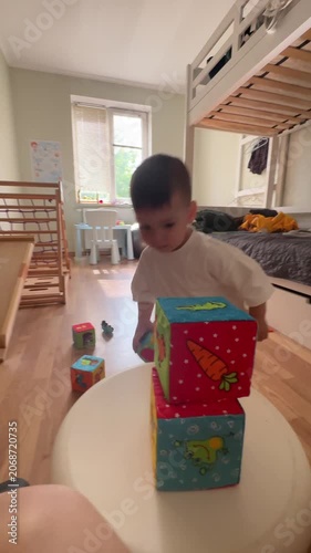 Toddler stacking colorful blocks at home