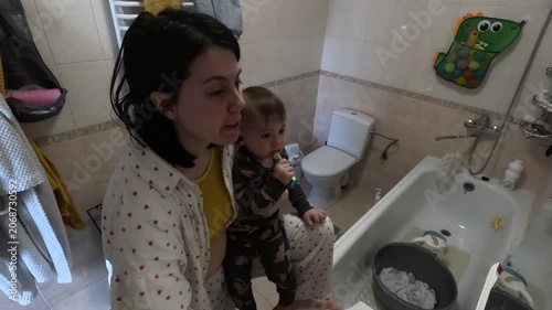 Mother and Child Brushing Teeth Together