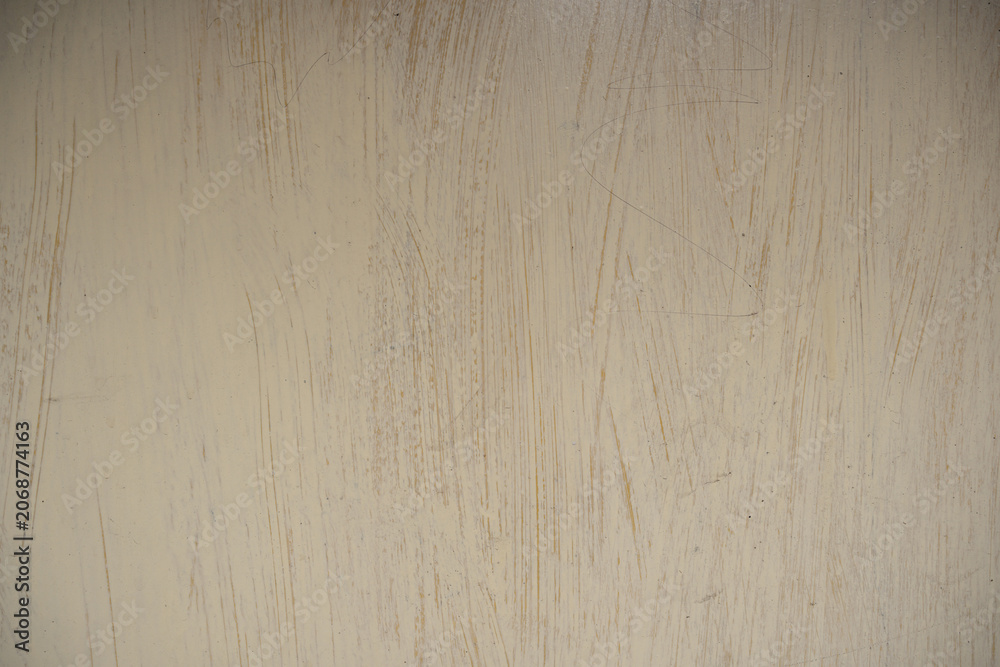 Obraz premium Scratched beige painted texture. Worn out pale yellow grunge surface background with distressed lines and empty copy space.