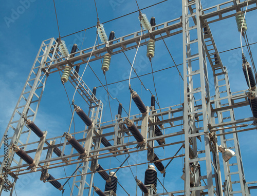High voltage electrical substation against blue sky, power grid infrastructure