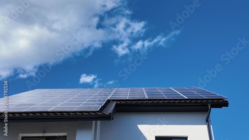 Solar PV modules mounted on a rooftop of a house, green energy.
