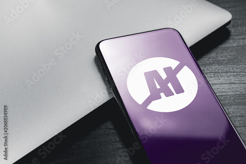 No AI symbol displayed on smartphone screen beside laptop. Artificial intelligence restriction, ethical technology debate and human created content concept. High quality photo