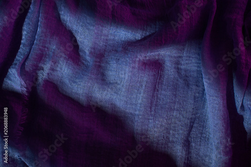 Colorful fabric with shadow patterns reflecting light in a studio setting during the day