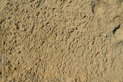 Fotografija Golden quarry sand layer close-up with uneven granular compression, highlighting