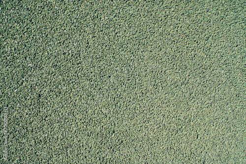 Aesthetic geometric background of textured outdoor green rubber mat pavement