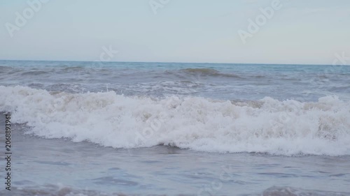 Center ocean surf progressing from rising swell to gentle retreat at near end of sequence