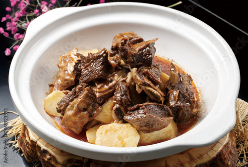 Potato and Steak Steak in a White Clay Pot