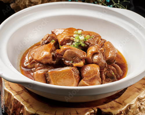 Braised goose pieces served in a white casserole