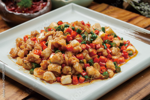 Stir-fried rabbit with millet peppers served on a square celadon plate